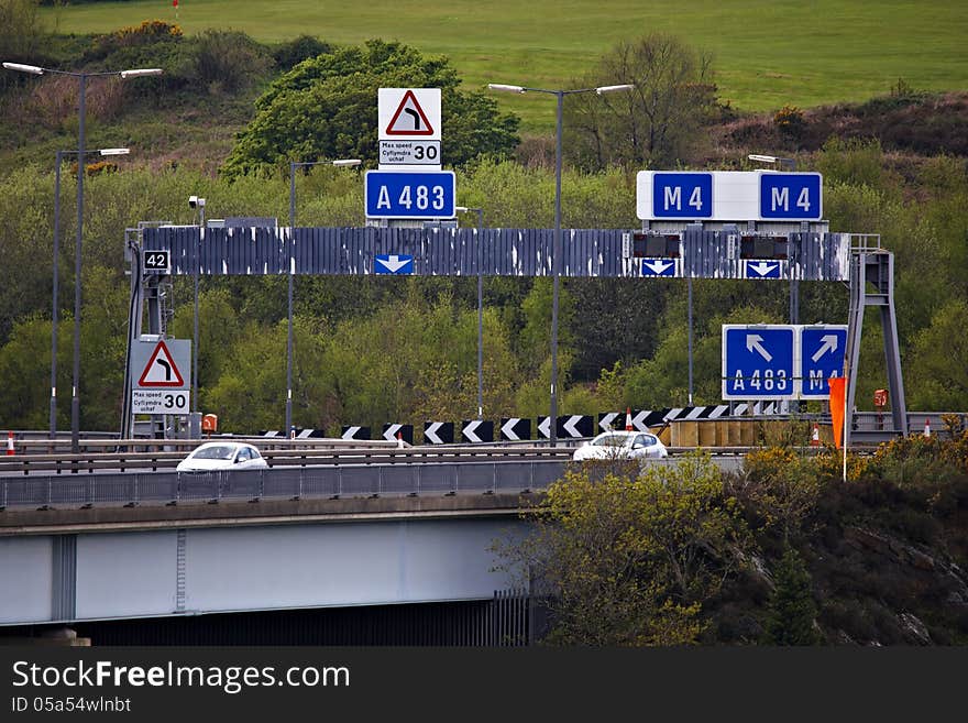 Motorway overhead gantry and signs on elevated section of M4 motorway in Swansea. Motorway overhead gantry and signs on elevated section of M4 motorway in Swansea