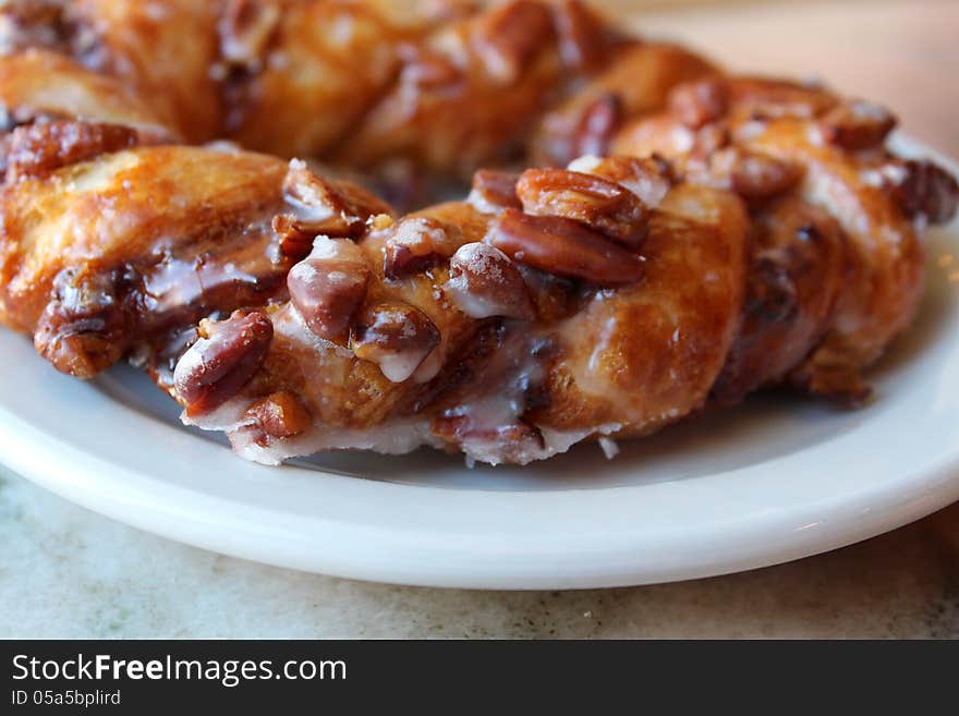 Braided pastry filled with pecans and glazed with sugar