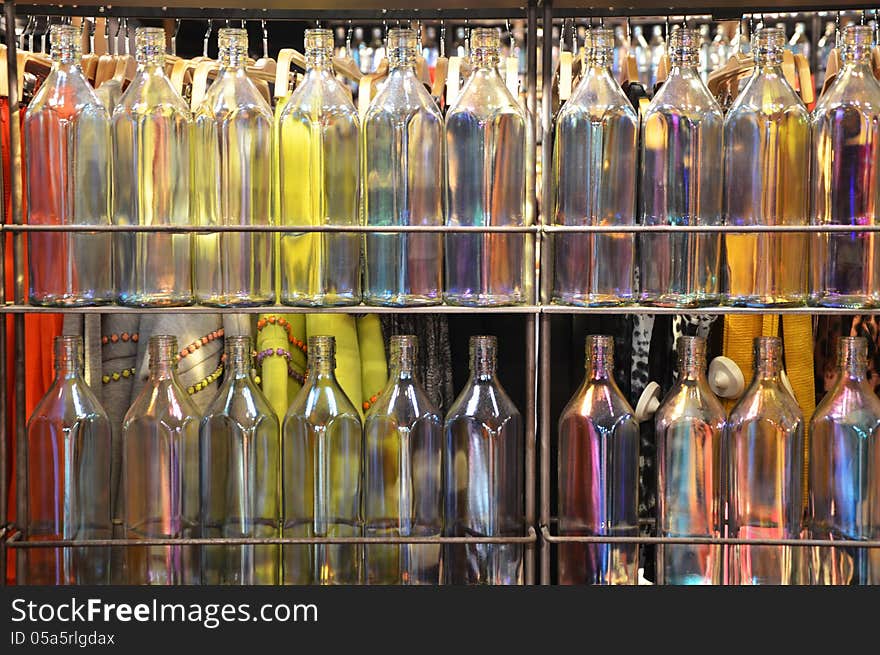 Multi-colored bottles on glass shelves