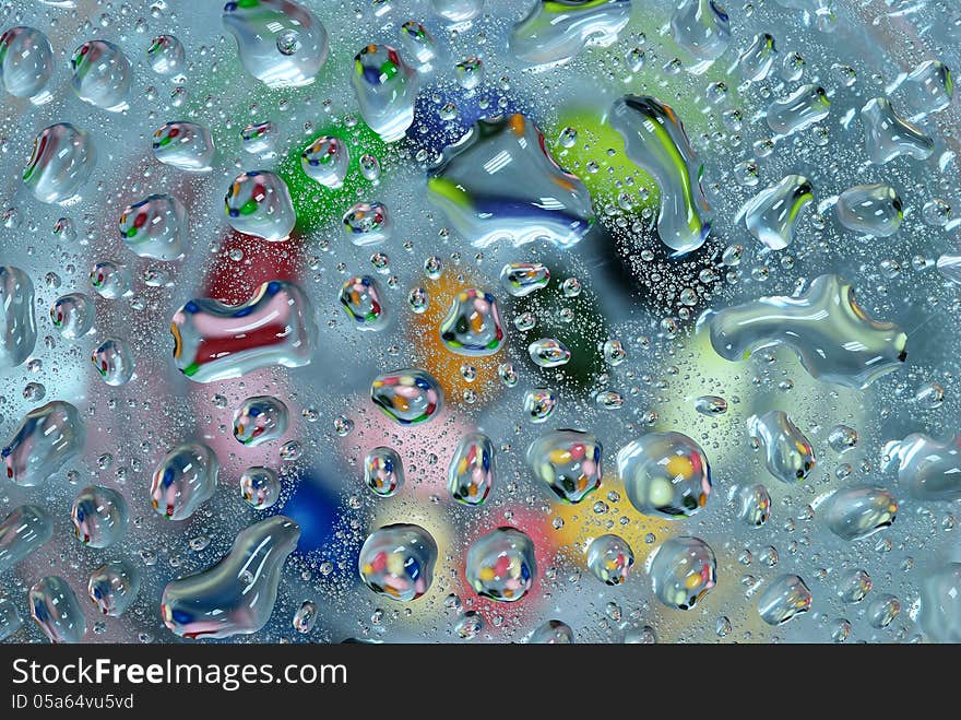 Colorful water drop on glass plate background