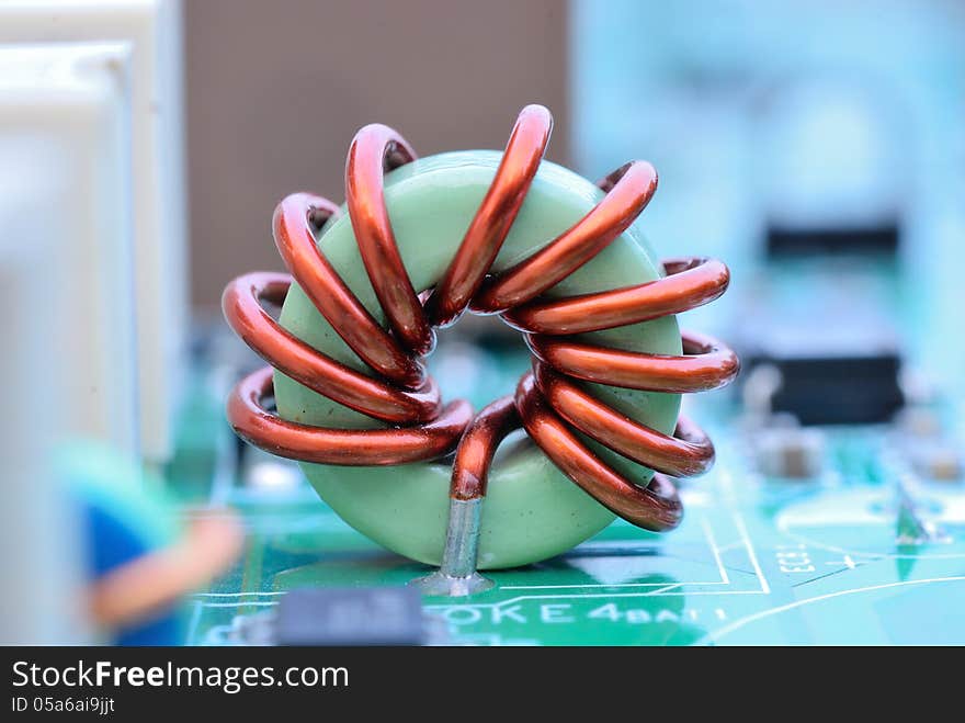 Close up of an electronic printed ferrite ring with mainboard background. Close up of an electronic printed ferrite ring with mainboard background