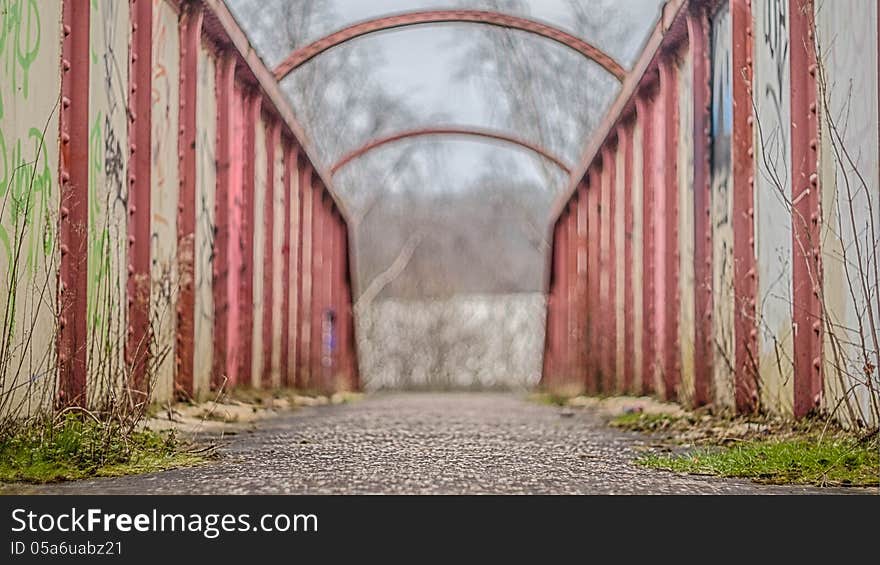 Overgrown Iron bridge with graffiti. Overgrown Iron bridge with graffiti