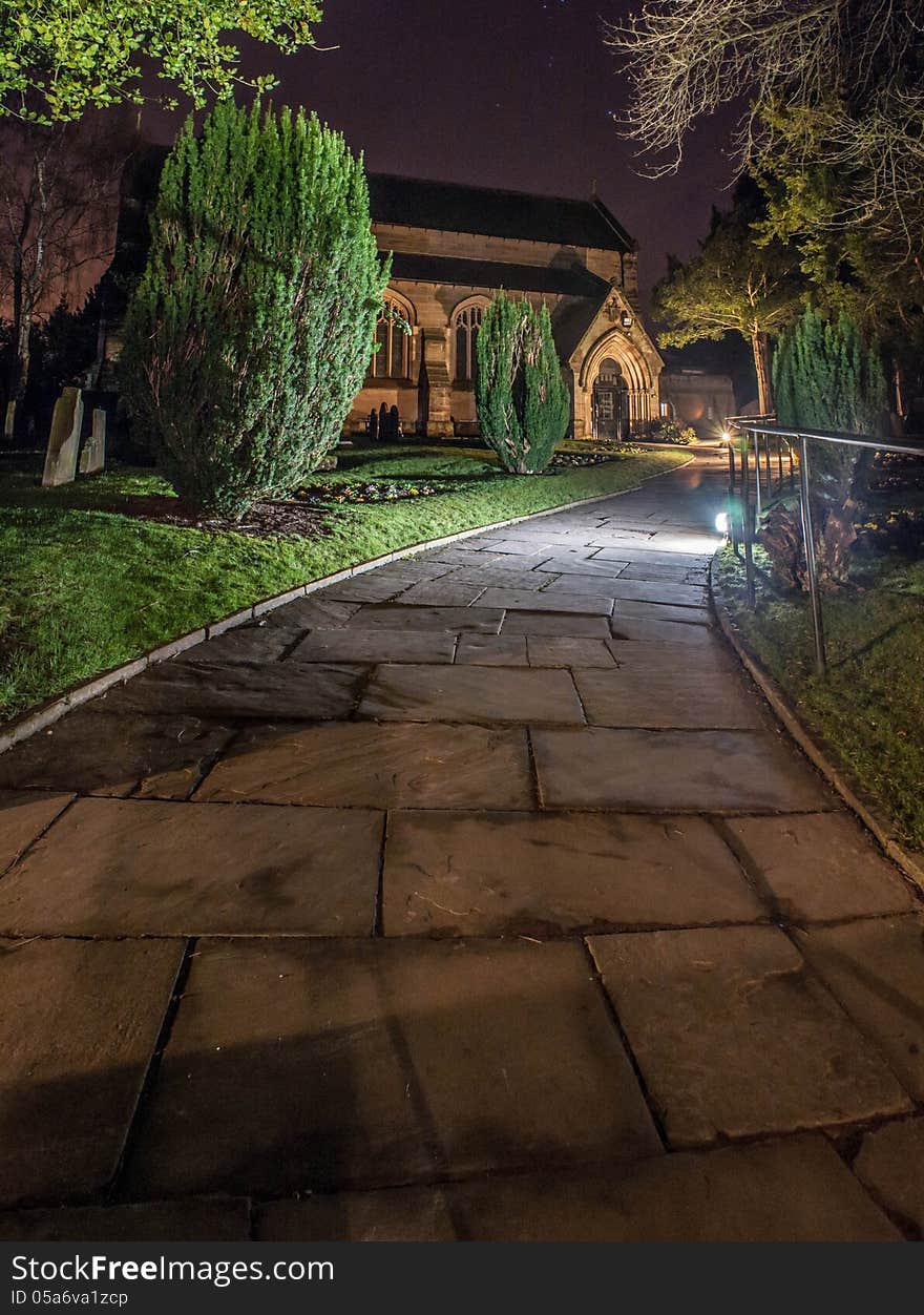 A church at night including church yard.