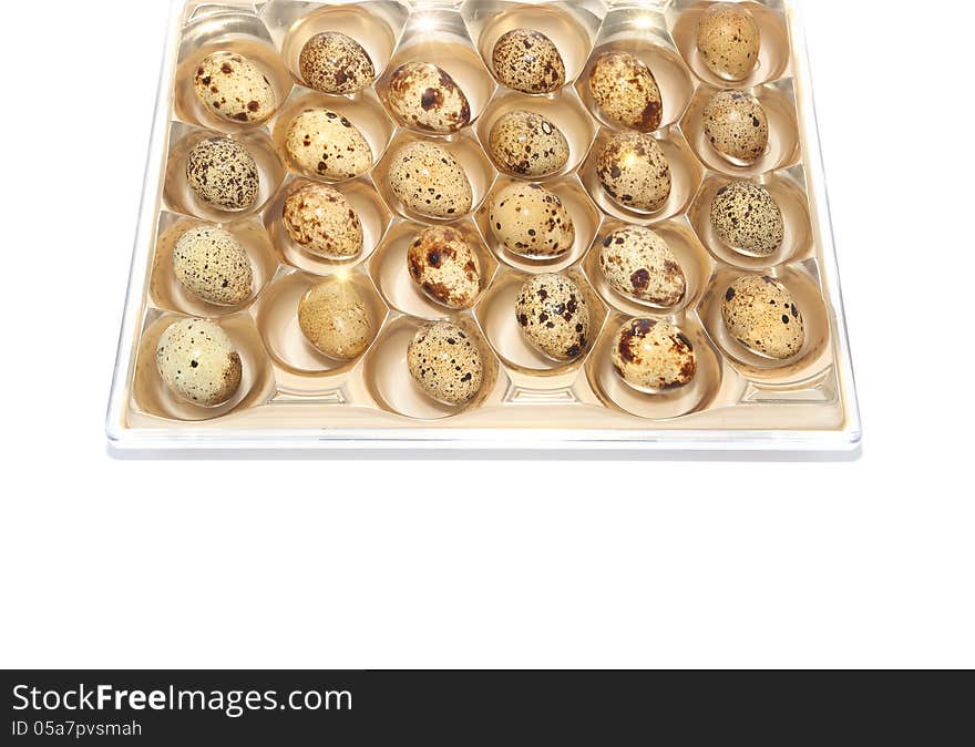 Quail eggs in package isolated on white. Quail eggs in package isolated on white