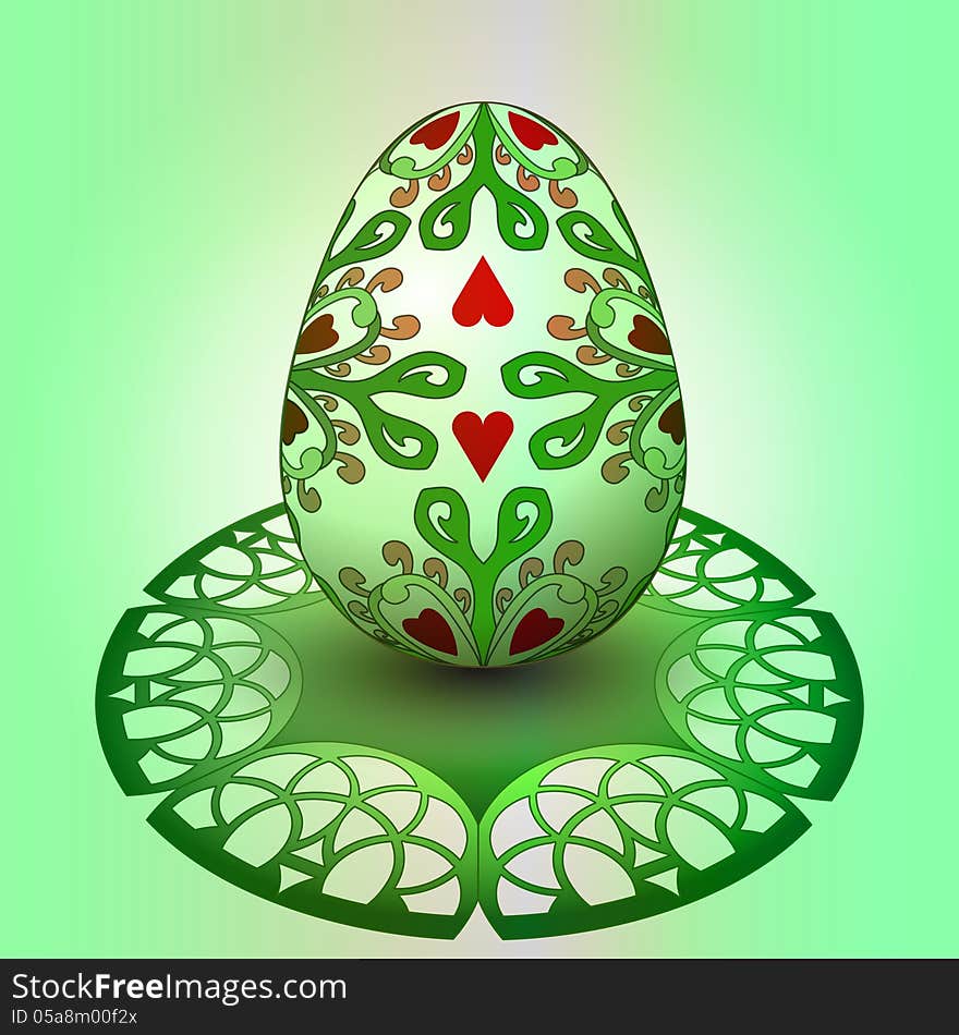 Handmade decorated easter egg on green tray