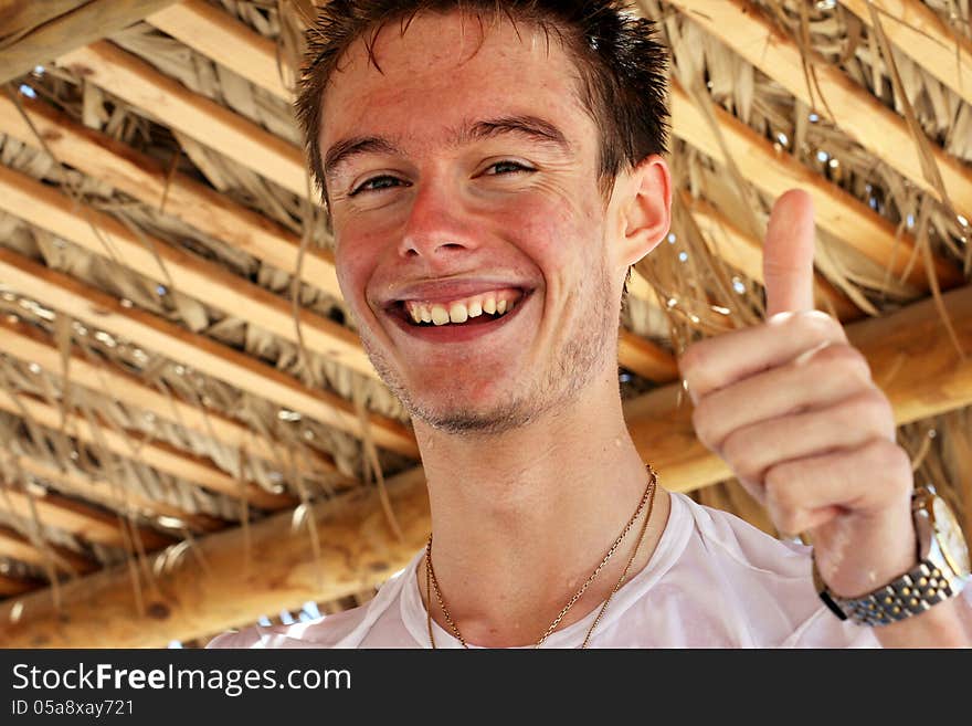 Happy smiling teenager enjoying the summertime at the beach.