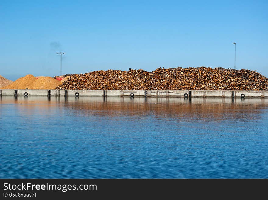 Stack of dried fire wood logs cut into chips for heating