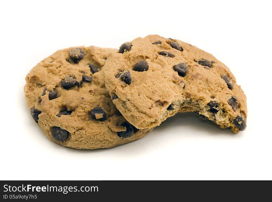 Two chocolate chip cookies with on with a bite out of it, on white background