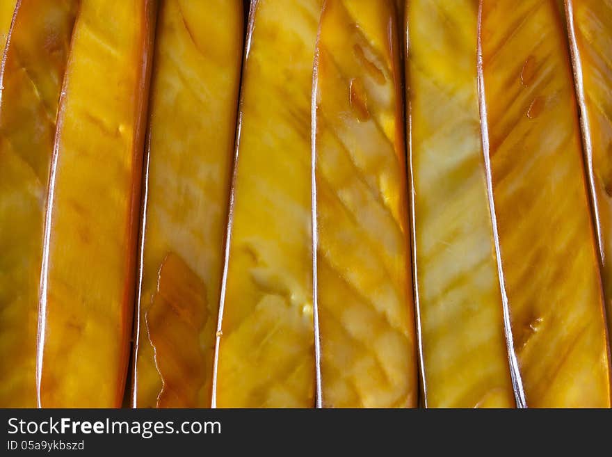 Closeup of a bracelet made with golden colour sea shells cut into lengths, polished and laid side by side. Closeup of a bracelet made with golden colour sea shells cut into lengths, polished and laid side by side.