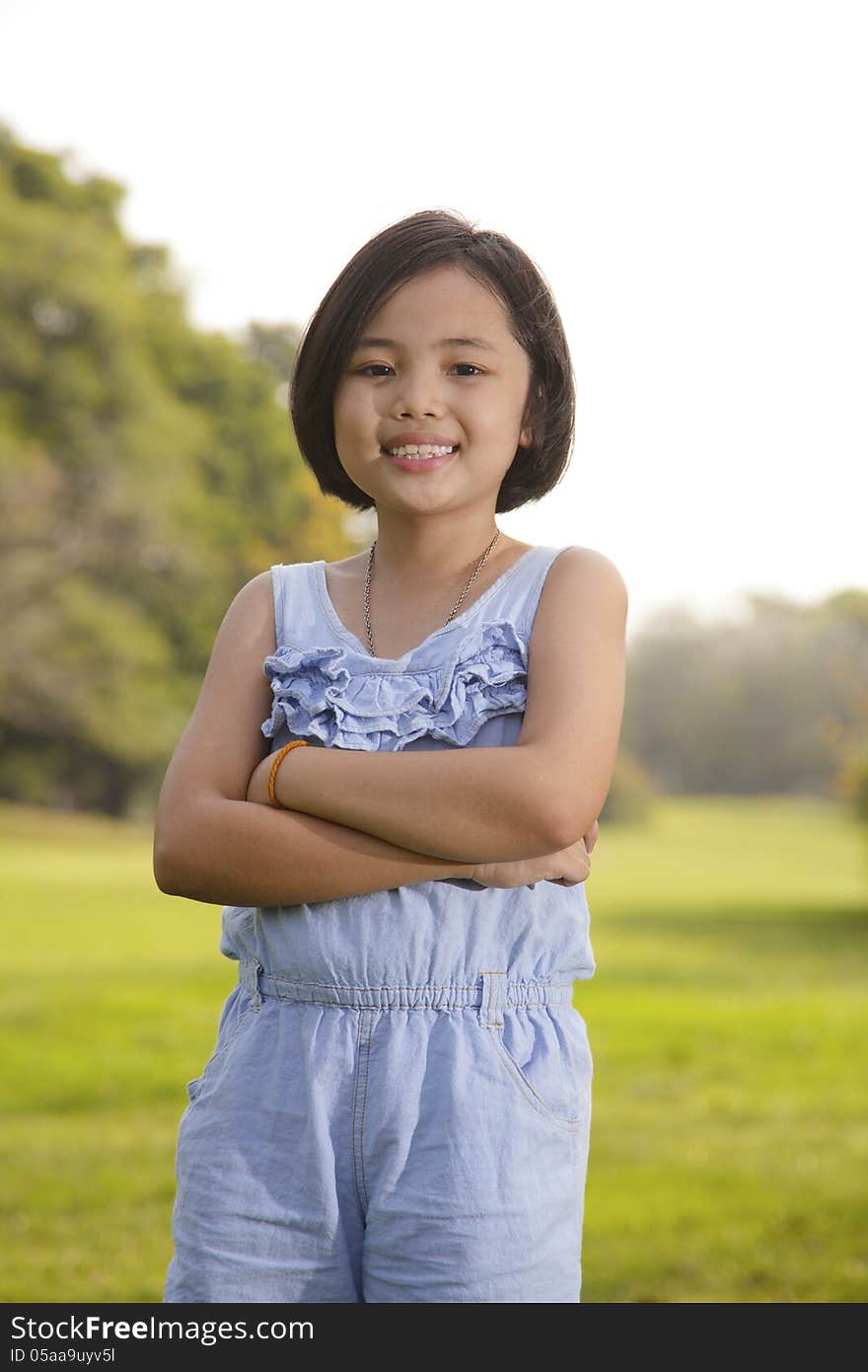 Asian little girl smiling happily in the park