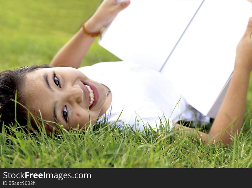 Girl Relax And Reading A Book In The Park