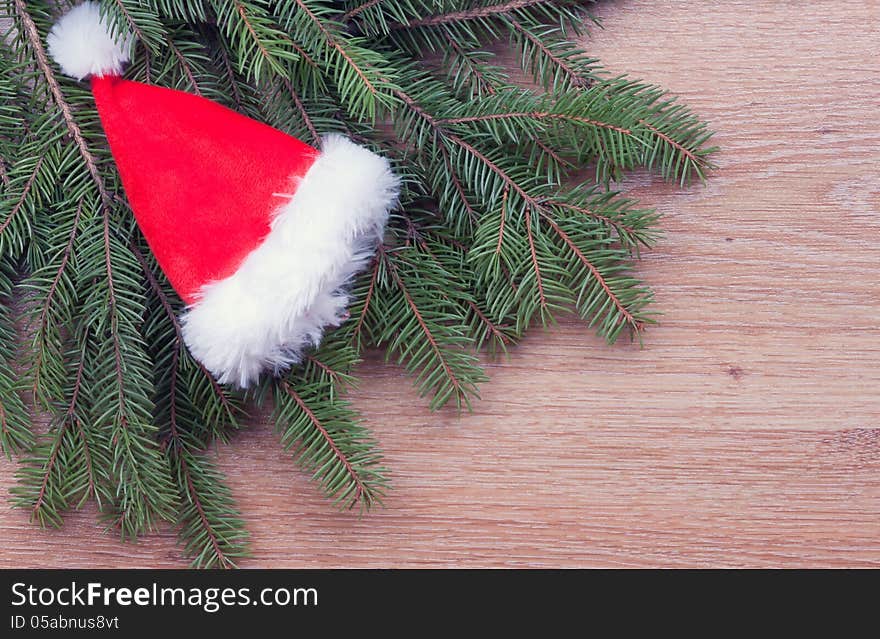 Santa's hat hanging on fir branches. Santa's hat hanging on fir branches