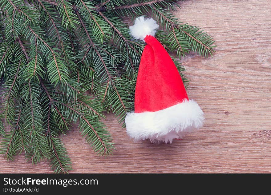 Santa's hat hanging on fir branches. Santa's hat hanging on fir branches