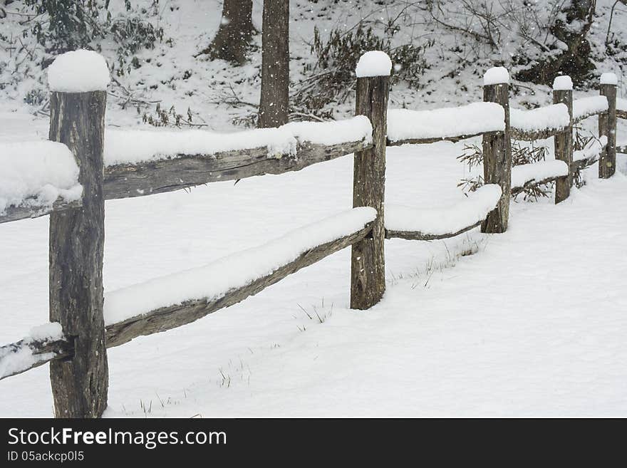 Snow Covering A Split Rail Fence.