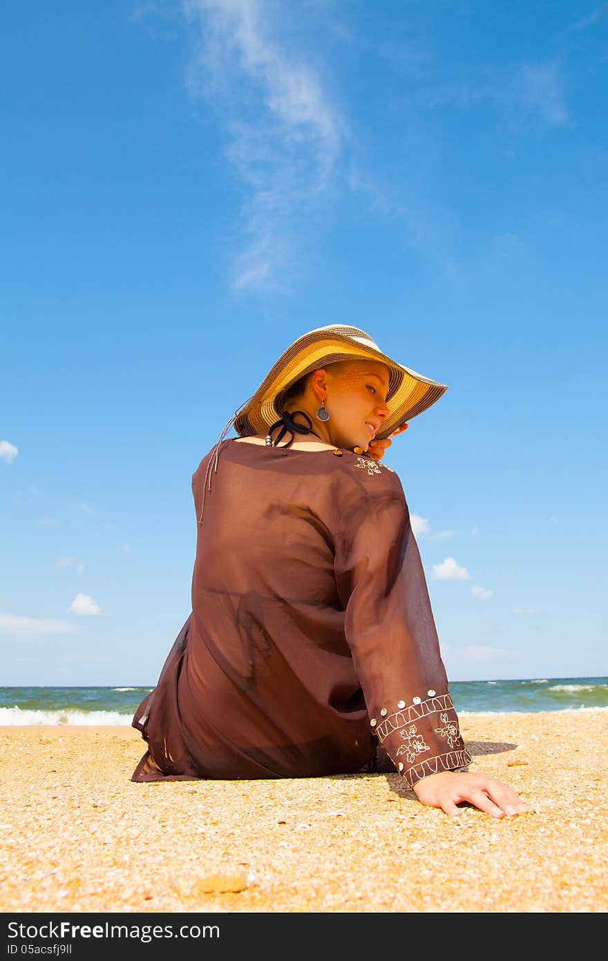 Girl in broun on a summer sea beach. Girl in broun on a summer sea beach