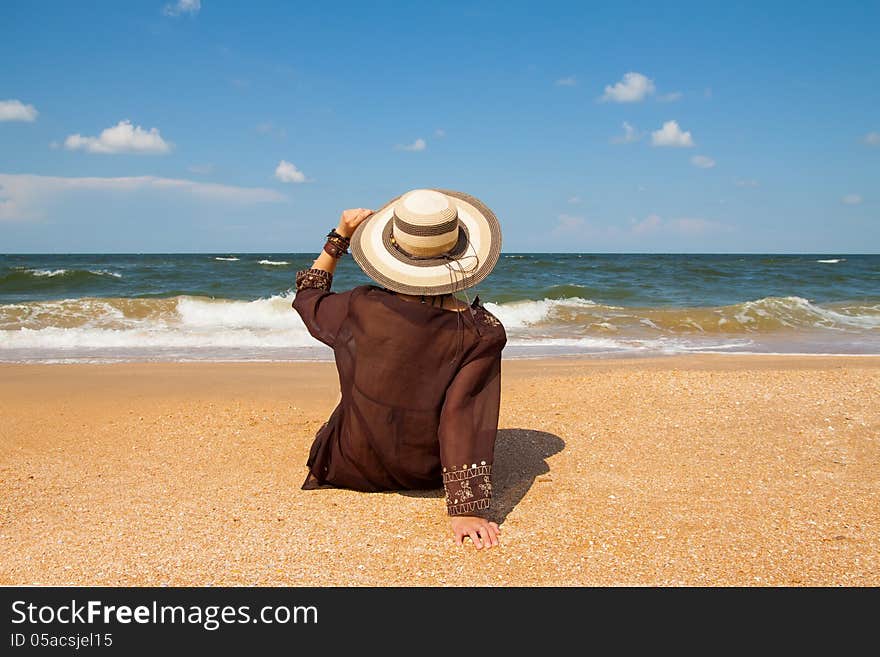 Girl in broun on a summer sea beach. Girl in broun on a summer sea beach