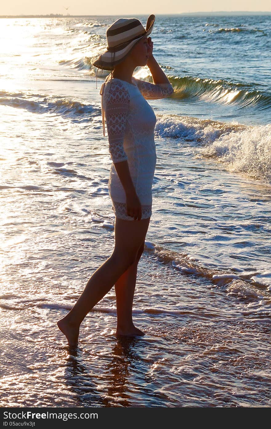 Young woman standing  in sea looking ahead