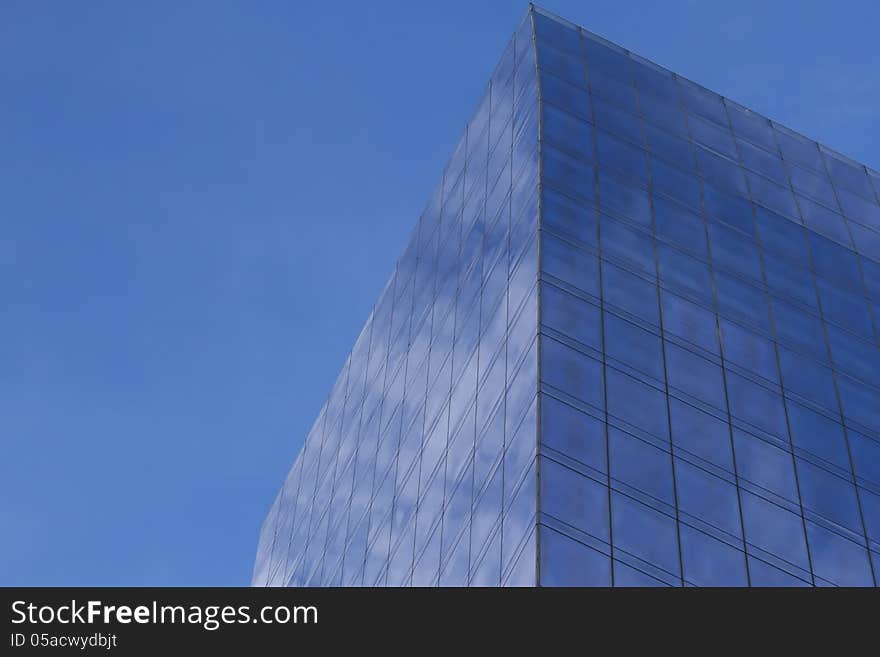 Modern business building with clouds reflection and blue sky in the byckground. Horizontally.