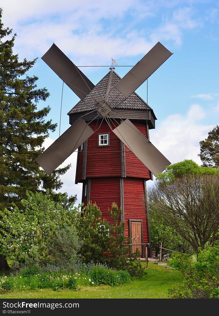 Old wooden windmill in countryside. Vertical frame