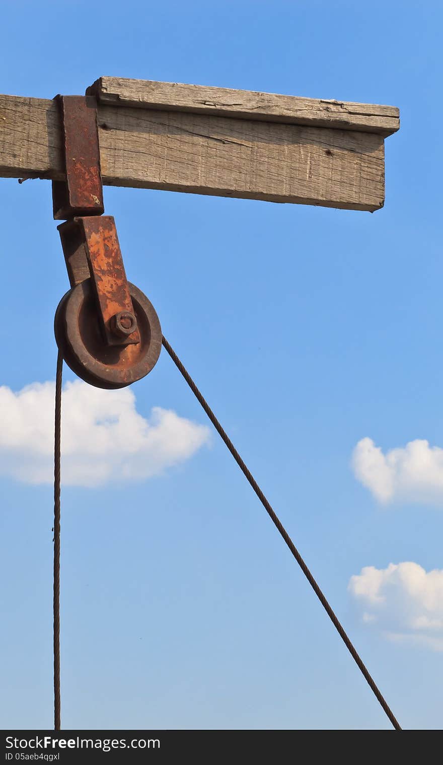 The rusty pulley with blue sky