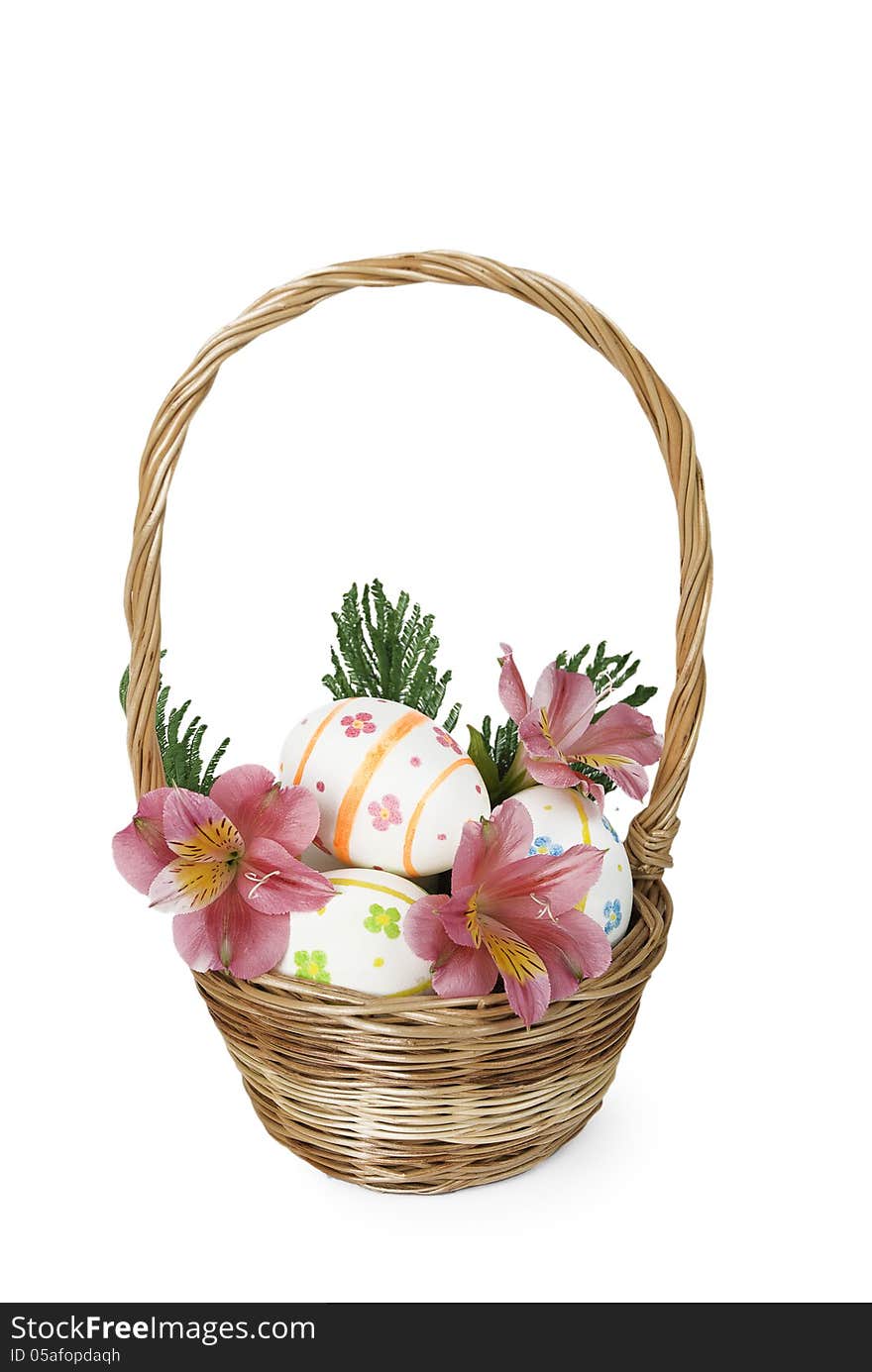 Easter eggs with pink flowers in a wicker basket. Easter eggs with pink flowers in a wicker basket