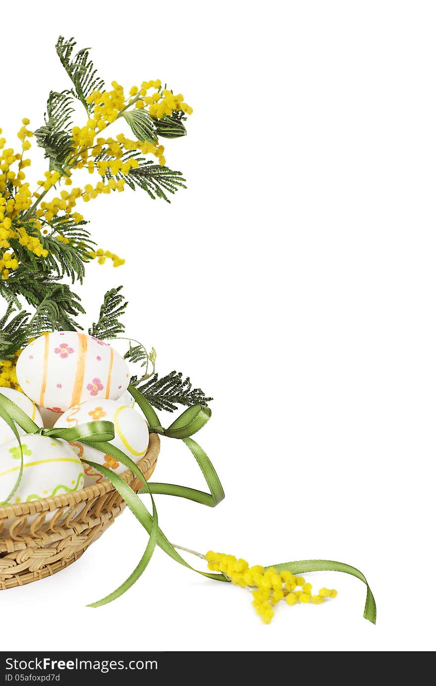 Easter eggs with yellow flowers in a wicker basket. Easter eggs with yellow flowers in a wicker basket