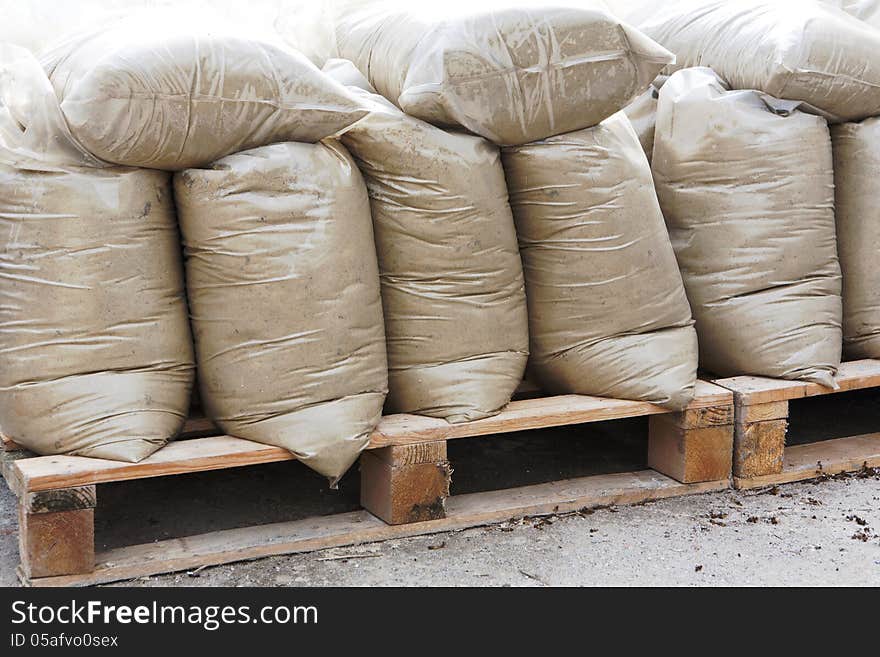 Construction mixtures on wooden pallet at storehouse