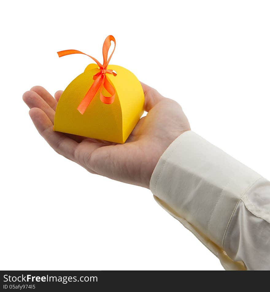 Man's hand holding gift paper box isolated white. Man's hand holding gift paper box isolated white