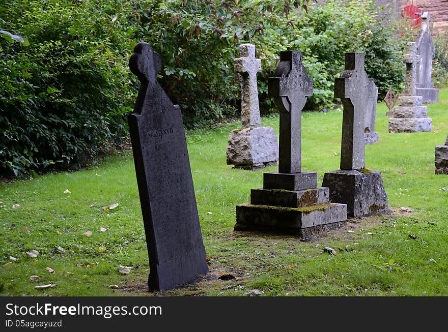 A row of tombstones at a graveyard