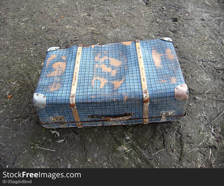 Old suitcase on the ground