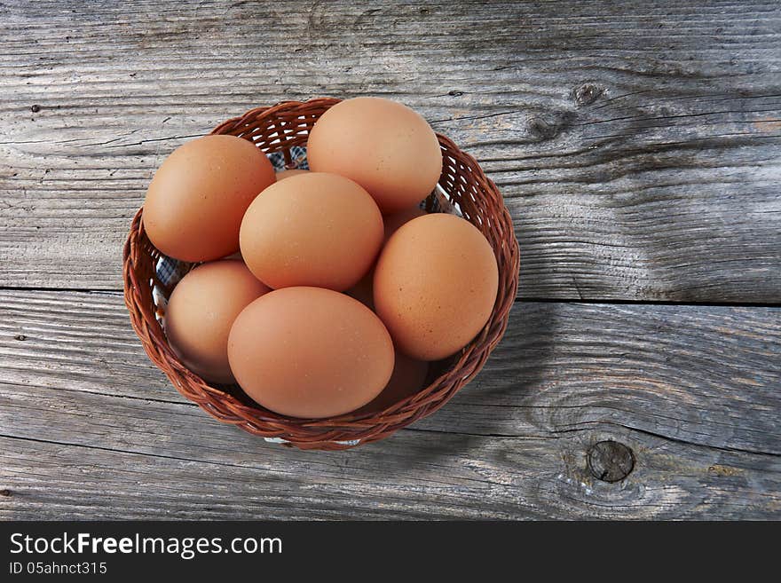 Easter egg in basket on vintage wooden background