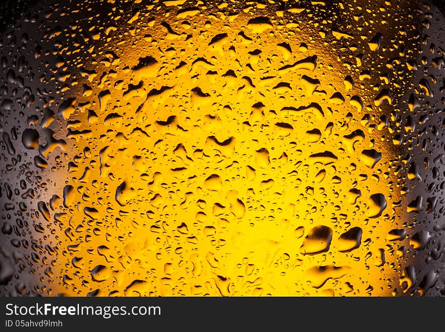 Сlose shot of drops on a bottle beer.