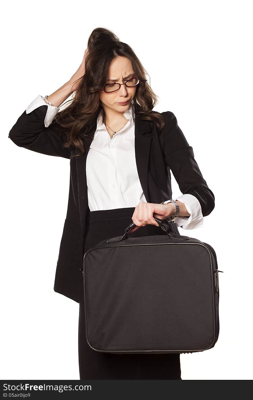 Worried business woman looking at the clock and holding the bag for laptop. Worried business woman looking at the clock and holding the bag for laptop