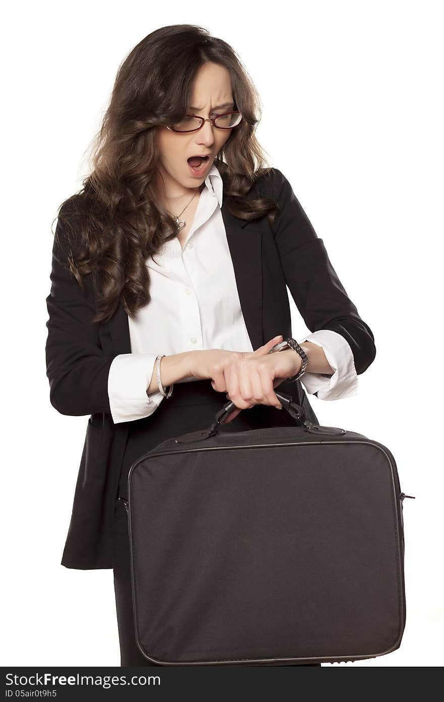 Worried business woman looking at the clock and holding the bag for laptop. Worried business woman looking at the clock and holding the bag for laptop