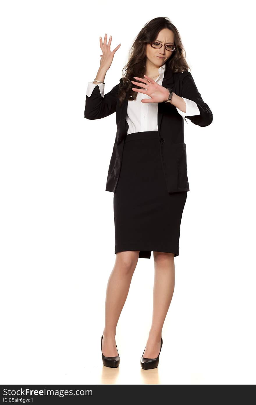 Worried business woman looking at the clock on white background