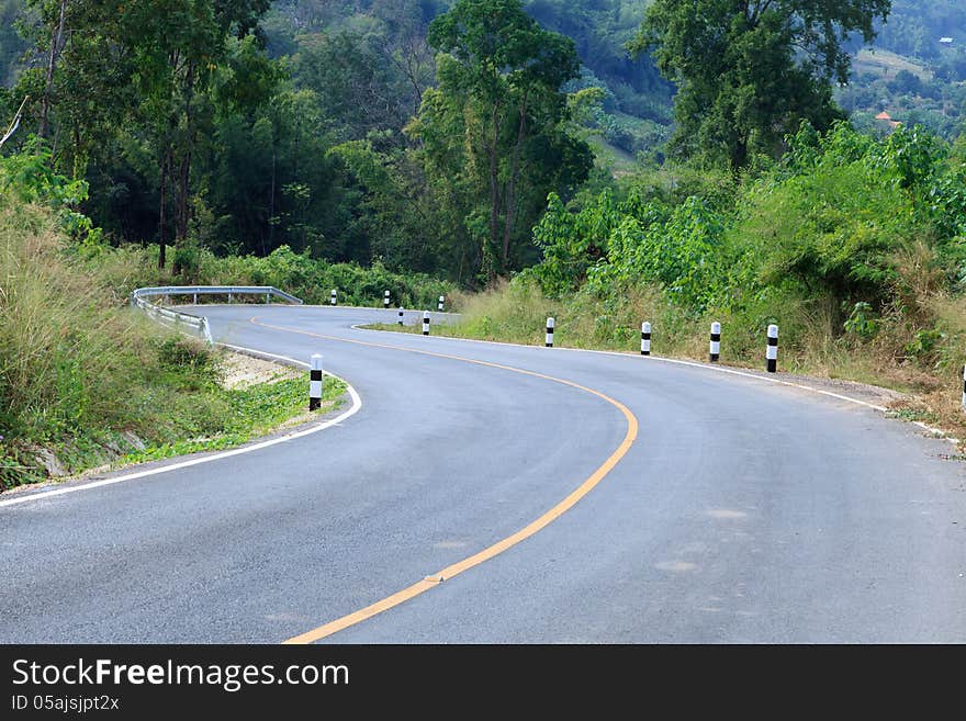 Curve Road With Yellow Line Down Hill