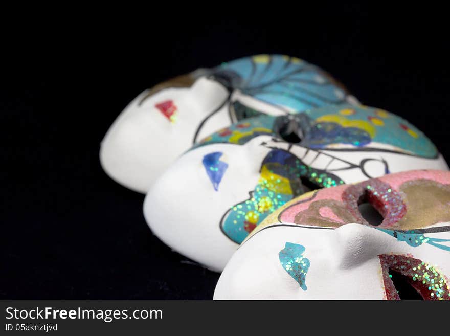 Traditional venetian carnival masks with black background.