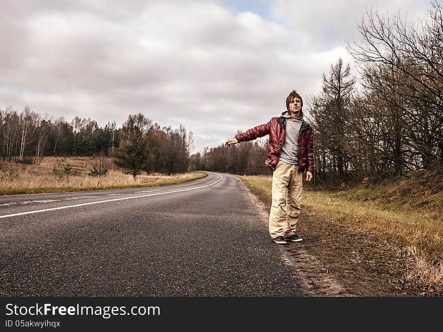 Man Hailing on a roadside of the road