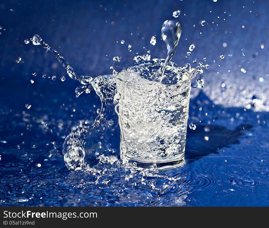 Water splashing out of the glass. Water splashing out of the glass