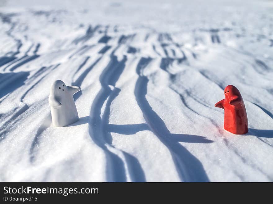 Two Little Lonely White And Red People Stay On Snow