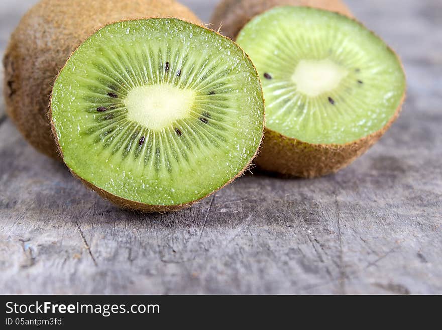 Close up of sliced fresh kiwi on wooden table top. Close up of sliced fresh kiwi on wooden table top