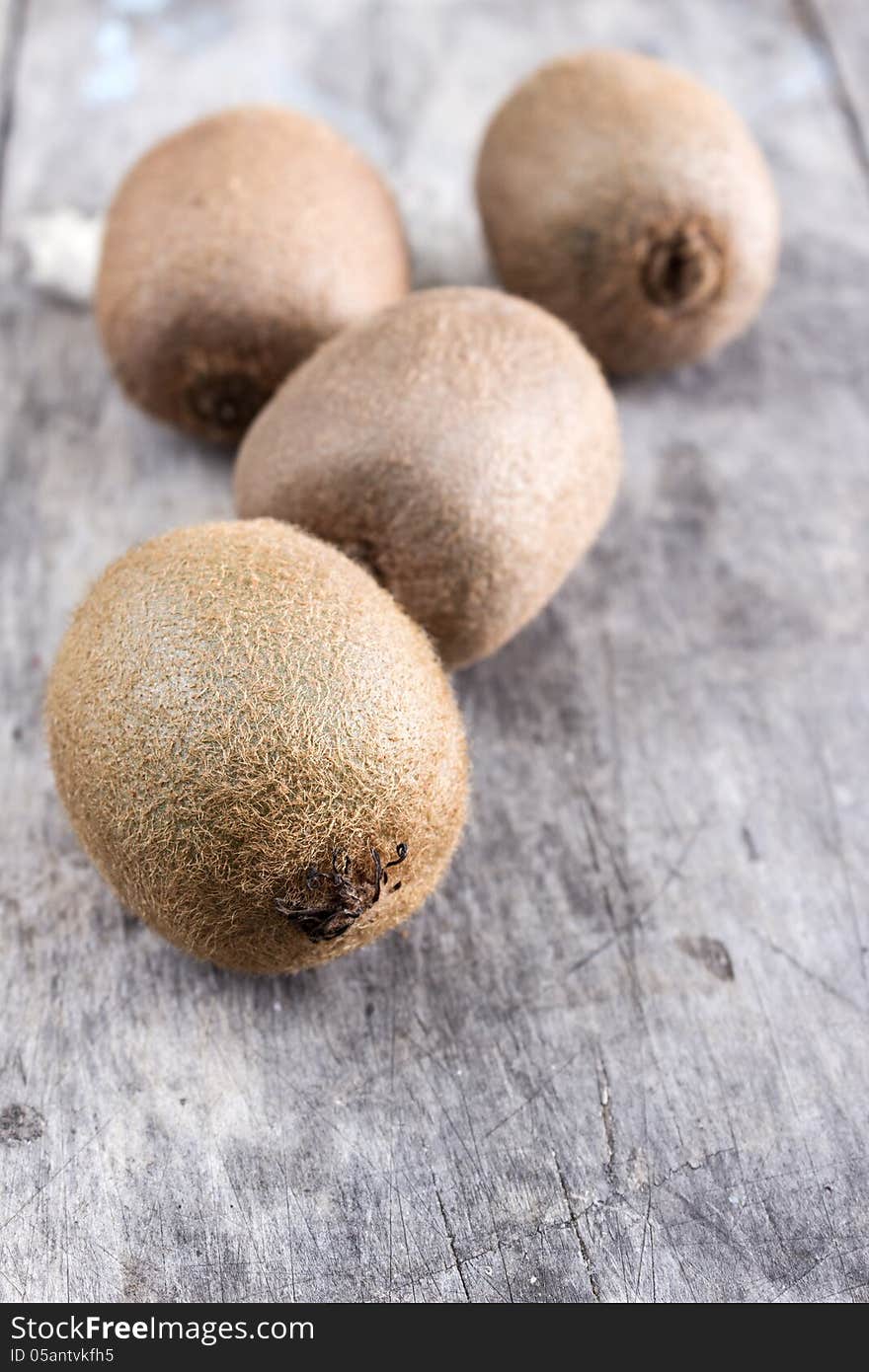 Close up of fresh kiwi on wooden table top. Close up of fresh kiwi on wooden table top