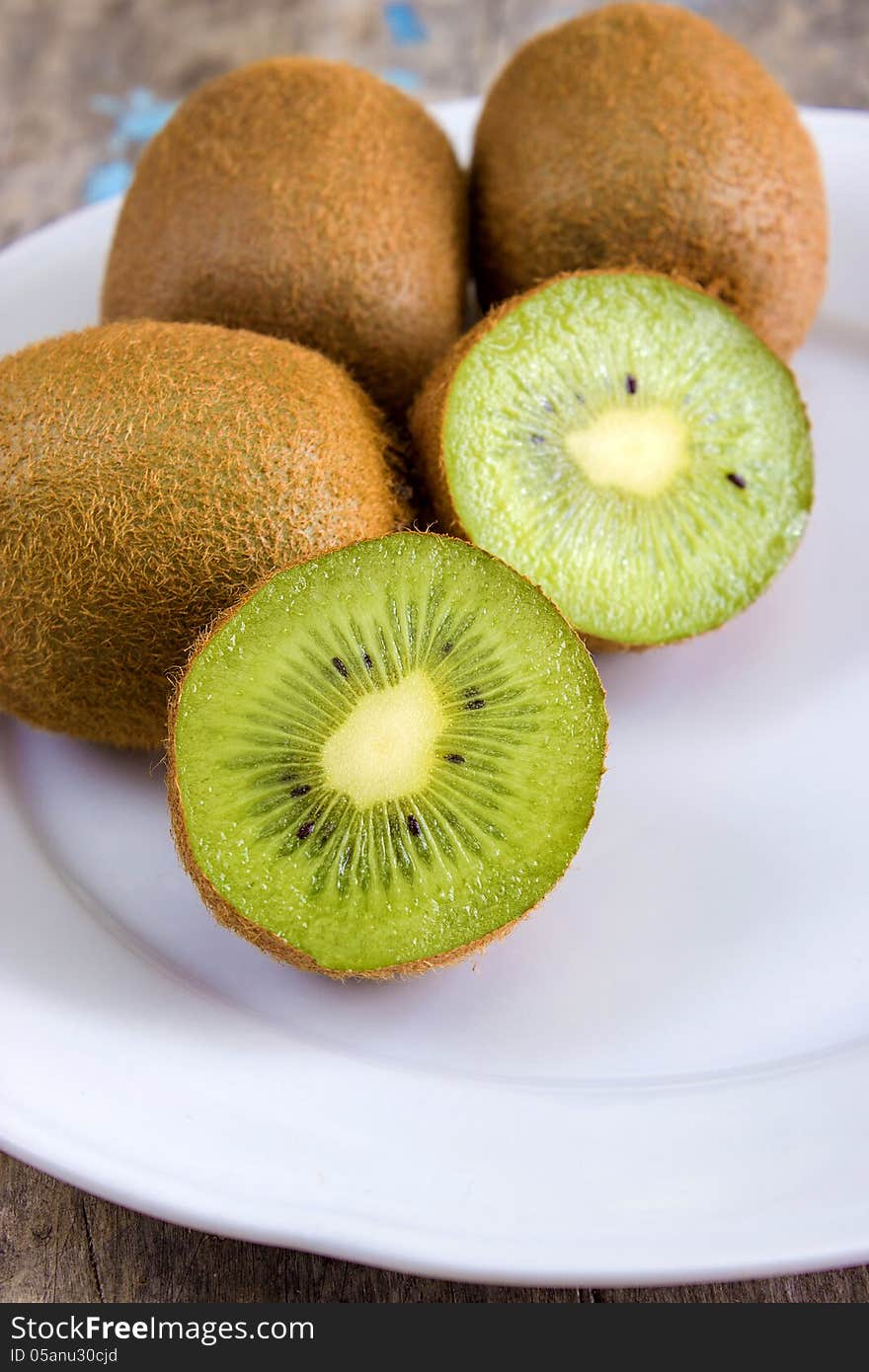 Close up of sliced fresh kiwi on white plate. Close up of sliced fresh kiwi on white plate