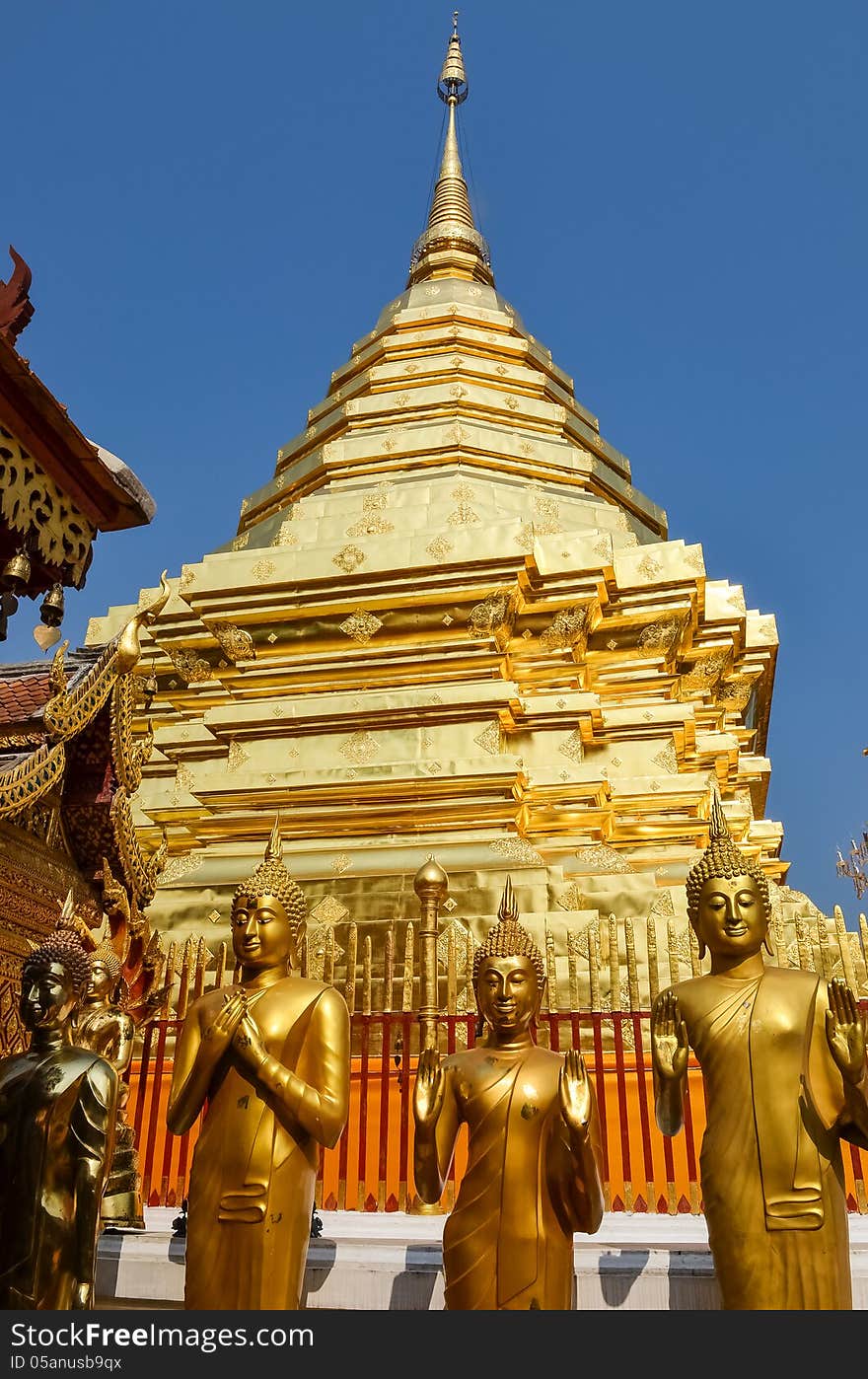 Golden temple and statues at Wat phra That in Doi Suthep, Chiang Mai, Northern Thailand. Golden temple and statues at Wat phra That in Doi Suthep, Chiang Mai, Northern Thailand