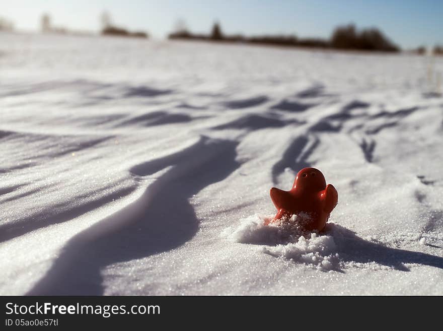 Little lonely red man stay on snow