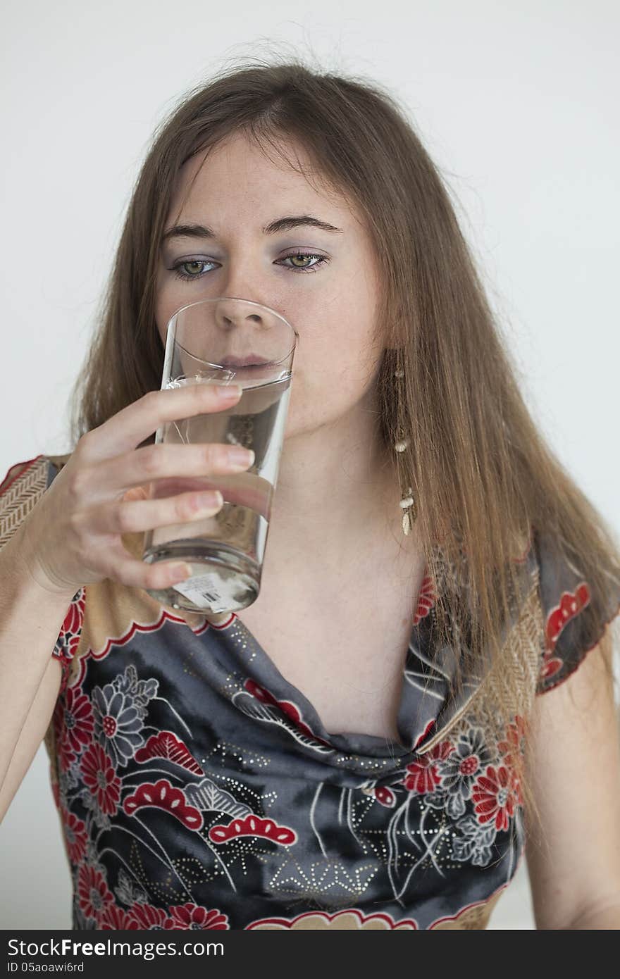 Young Woman With Beautiful Green Eyes Drinking Glass Of Water