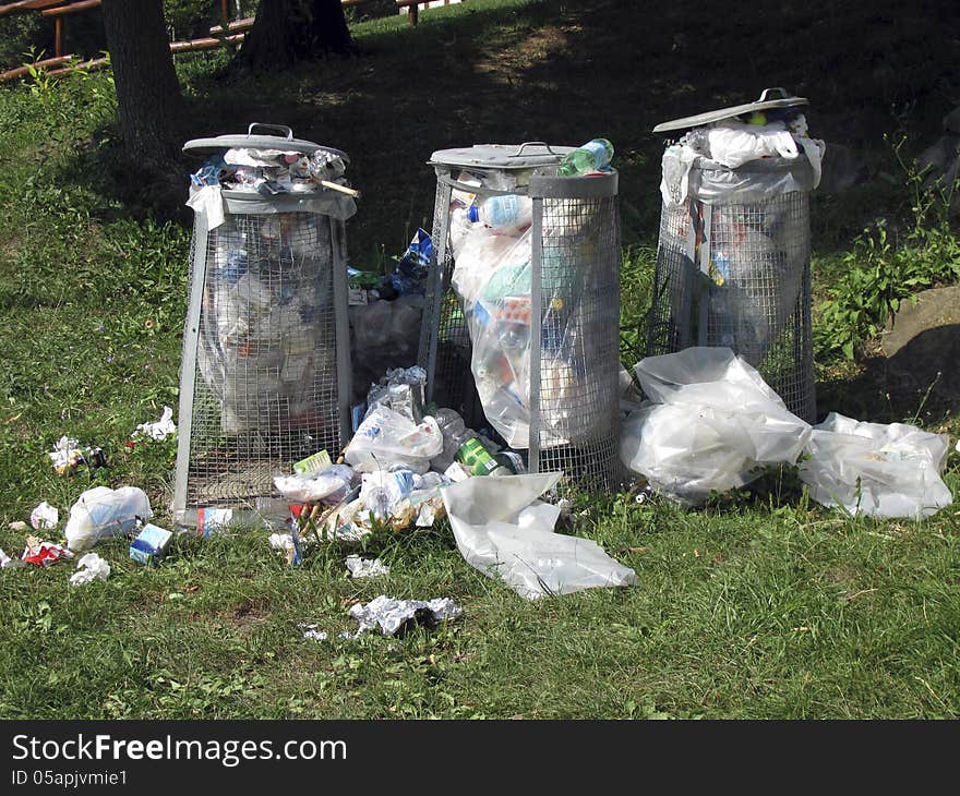 Three trash cans in the woods. Three trash cans in the woods