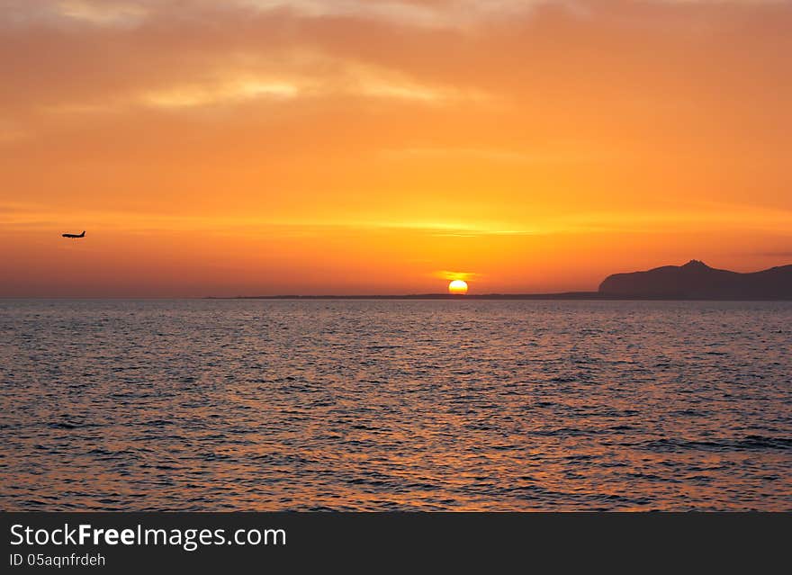 Sunset island sea sky fly orange seascape. Sunset island sea sky fly orange seascape