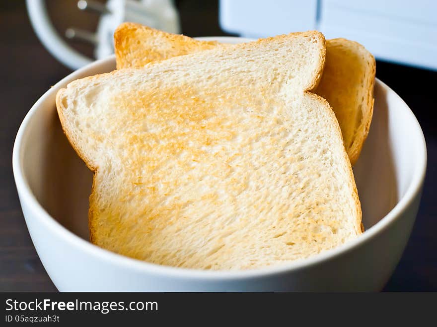 Two toast in cup on the table.