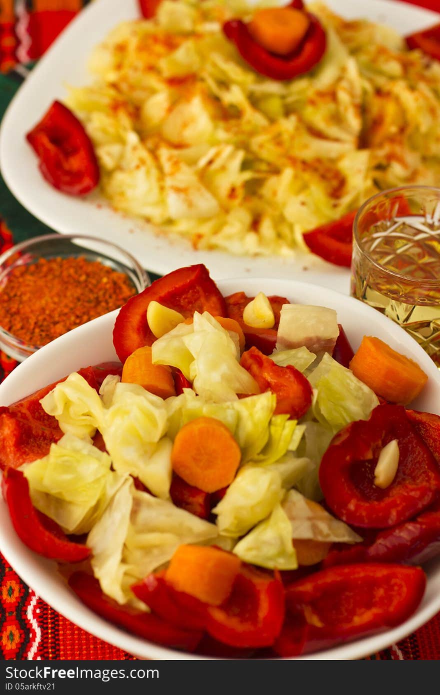 Salad in cup and plate with aperitif served on table. Salad in cup and plate with aperitif served on table.